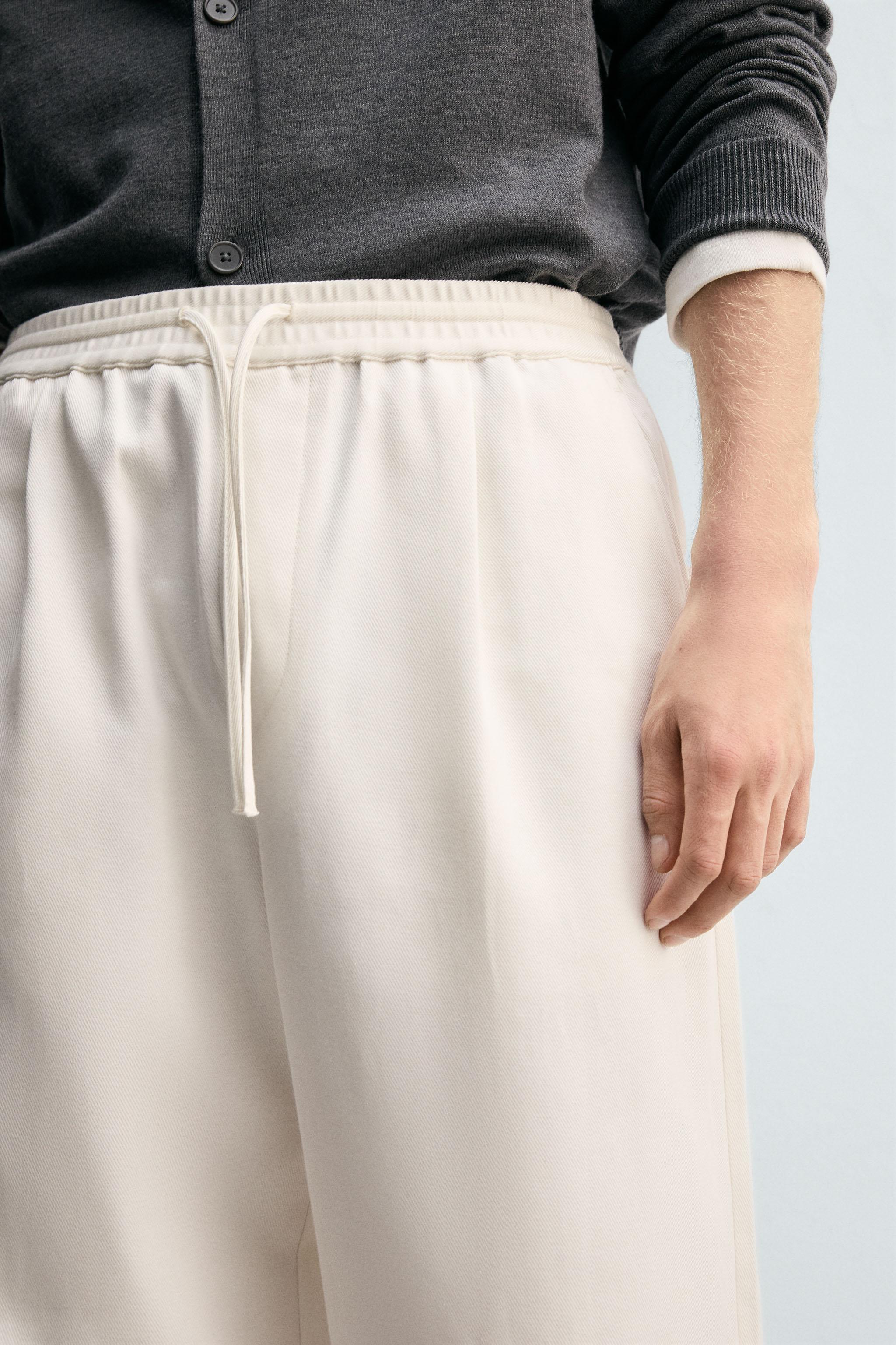 TEXTURED PLEATED PANTS